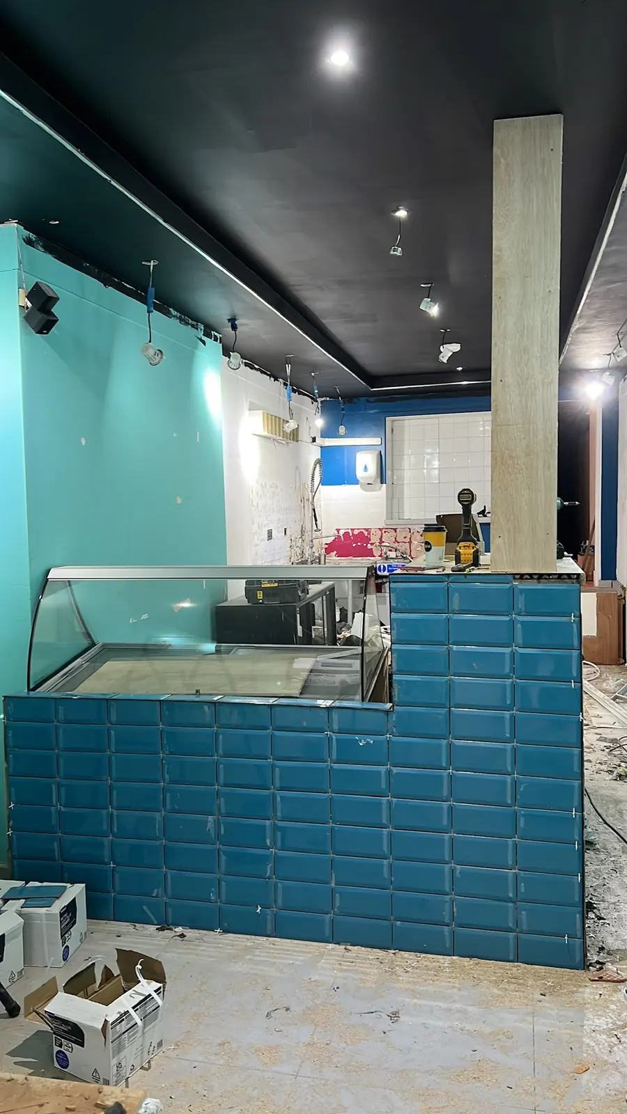 Teal-tiled dessert counter with curved glass display cabinet, Brentwood