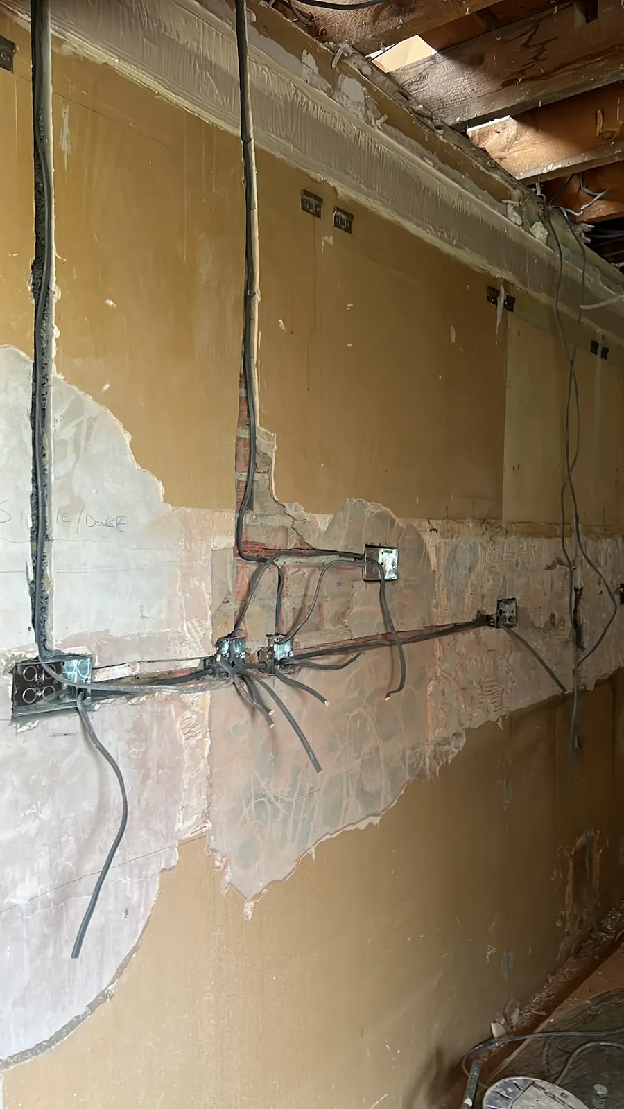 Exposed wall during first-fix rewiring, Upminster